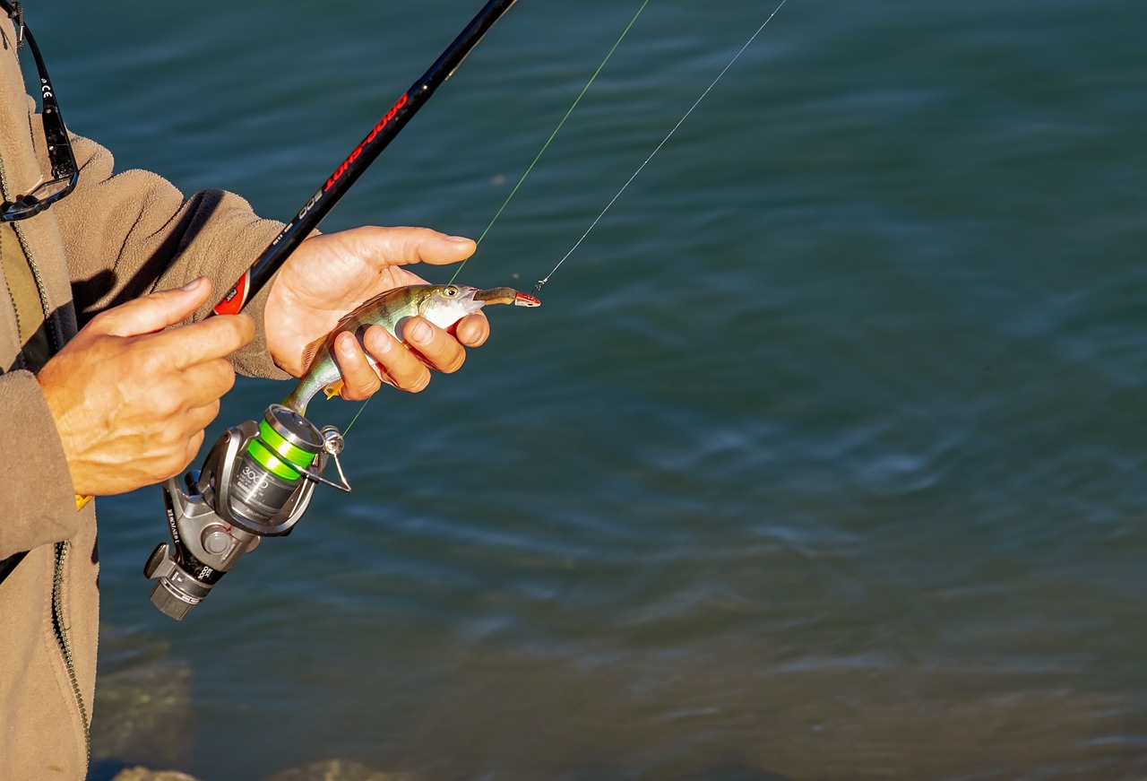 Man with fishing rod and bait, during a Fishing holiday in West Wales