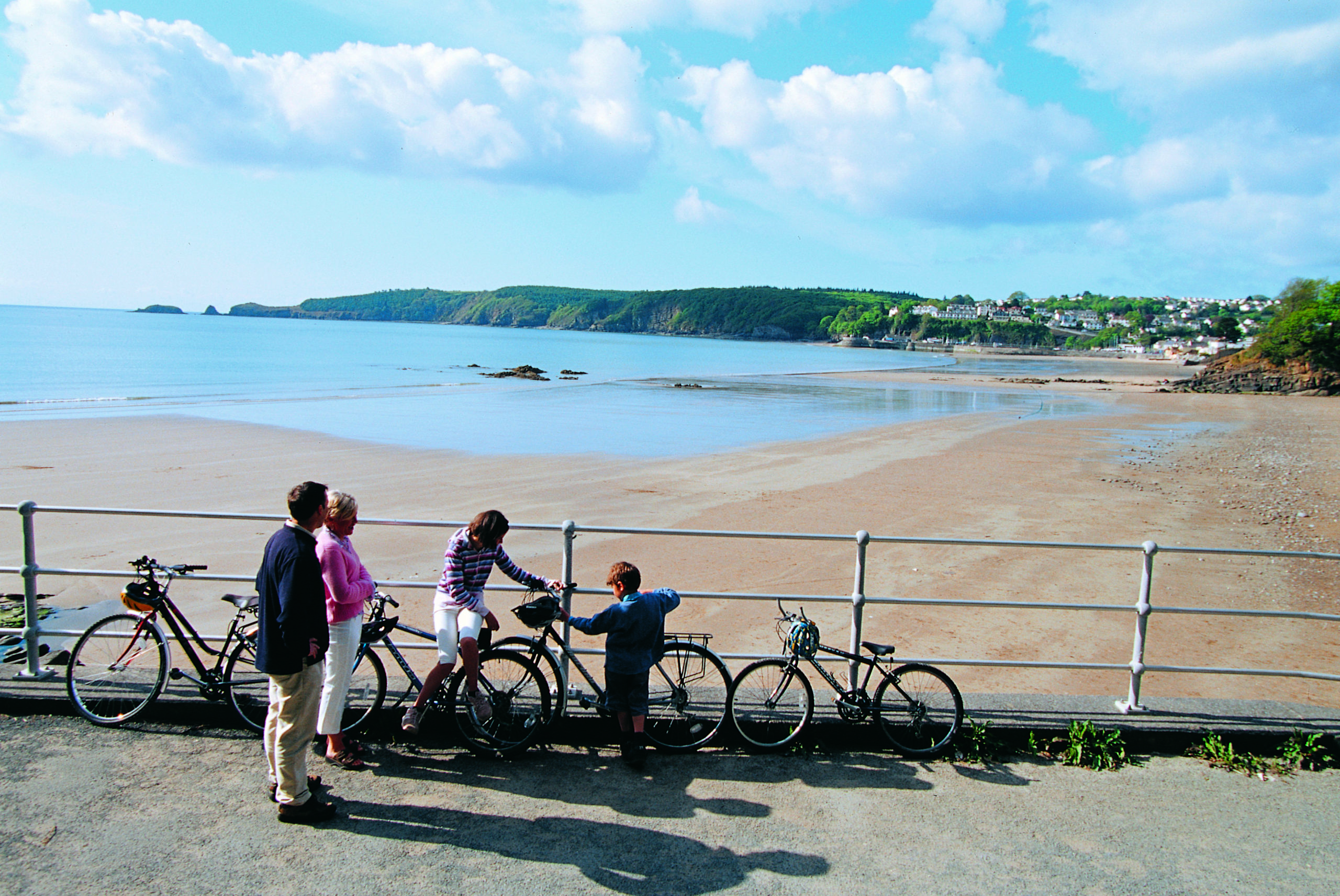 Family with bikes looking out over Saundersfoot Beach